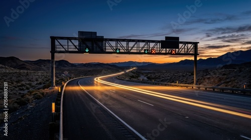 Desert Highway Light Trails Under Dramatic Twilight Sky With Overhead Sign