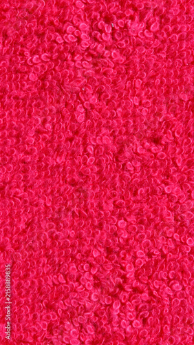 Vibrant Red Loop Terry Cloth Fabric Texture Background. Detailed macro photograph showing soft plush pink red terry towel loops. Ideal for textile mockups and abstract surface designs.