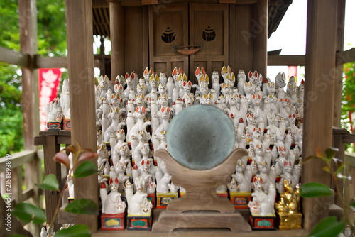 Fotografie June 6, 2020, Sendai, Japan: Small fox statues and mirror offered at Atago Shrine in Sendai city