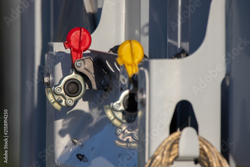 Close-up of red and yellow air brake couplings on truck trailer – pneumatic brake system and transport equipment photo