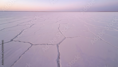 A breathtaking high-angle wide landscape photography shot of a vast dry salt flat desert