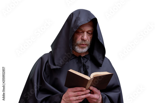 Cuadro en lienzo Solemn hooded monk reading an old book isolated on white