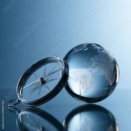 Global economic outlook compass globe navigation glass sphere blue reflection travel concept map exploration direction finance forecast