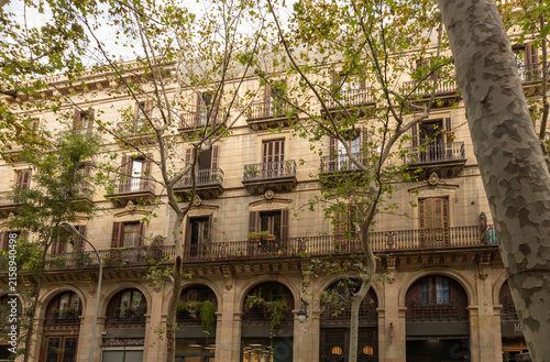 Historic Barcelona Residential Building With Balconies, Wrought Iron Facade and Street Trees