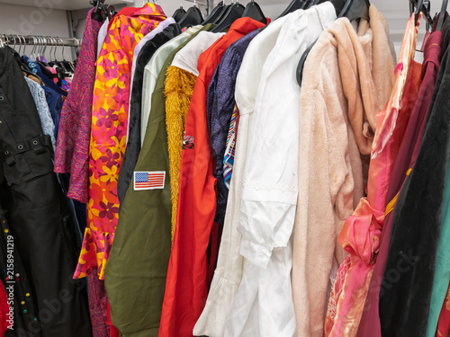 Bild auf Leinwand Carnival Costumes Displayed in Clothing Store Rack