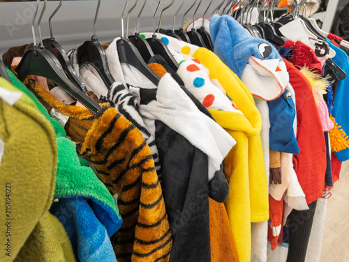 Foto Colorful Carnival Costumes Hanging in Store Rack