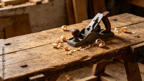 Vintage wood plane on rustic workbench with scattered wooden shavings