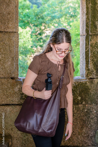 Woman Exploring Pambre Castle With a Handheld Camera