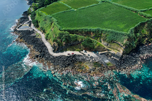 Aerial drone view of the natural volcanic pools of Santo Antonio on the rugged north coast of Sao Miguel, Azores, Portugal