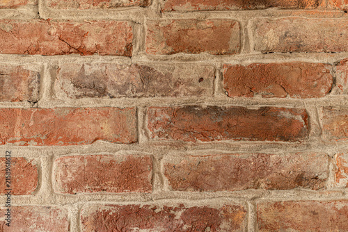 Quadro su tela Red brick wall texture with rough weathered masonry and cement mortar joints