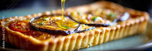 Eggplant and tomato pie with mozzarella served with olive oil at a local restaurant during dinner time