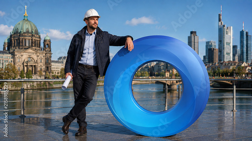 European Engineer Leaning Against a Blue O Ring Sculpture in a Modern City