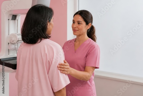 Healthcare worker comforting patient before mammogram