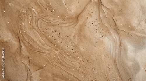Abstract natural background with flowing earthy textures and scattered fine particles