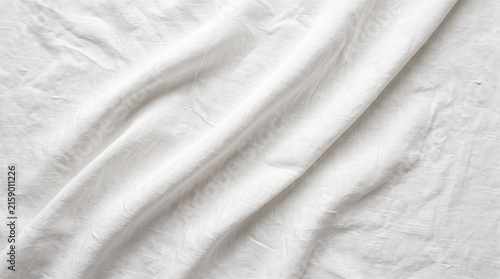 White crumpled fabric texture background with soft folds and wrinkles creating an abstract surface