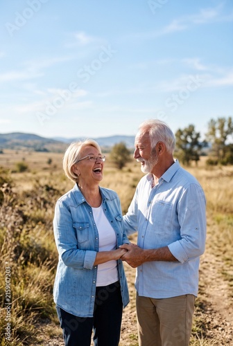 Happy senior couple laughing together during a countryside walk