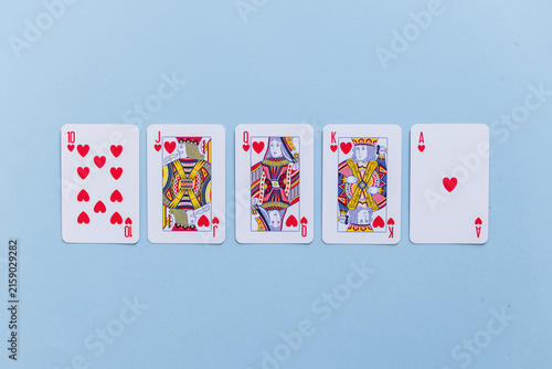 Cuadro en lienzo Royal flush hand of hearts playing cards arranged in a row on a light blue background