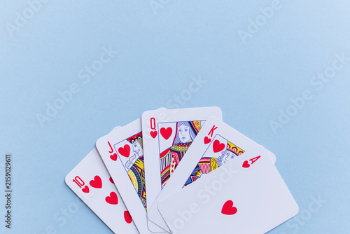 Cuadro en lienzo Royal flush hearts playing cards fanned out on a light blue background with copy space