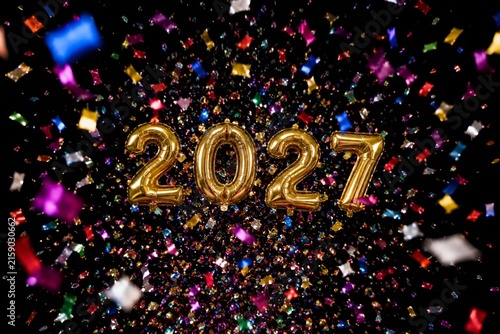 Gold 2027 balloons with colorful confetti on black background for New Year celebration.