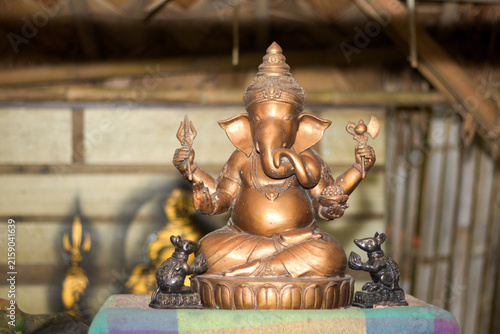 Bronze Ganesha statue seated on lotus with mice