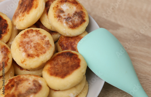Homemade delicious syrniki, cheese pancakes in a plate on the table