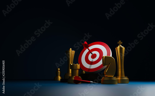 Business goals and strategic achievement concept with chess pieces, dartboard, and bullseye on a dark background