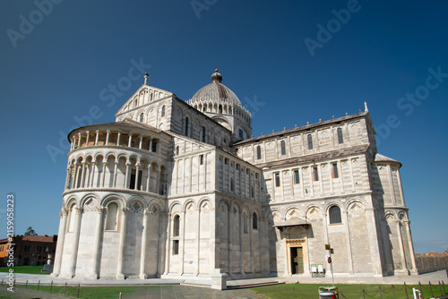 Принти на полотні Rear view of Pisa Cathedral in Piazza dei Miracoli, Tuscany, Italy, featuring historic Romanesque architecture under a clear blue sky