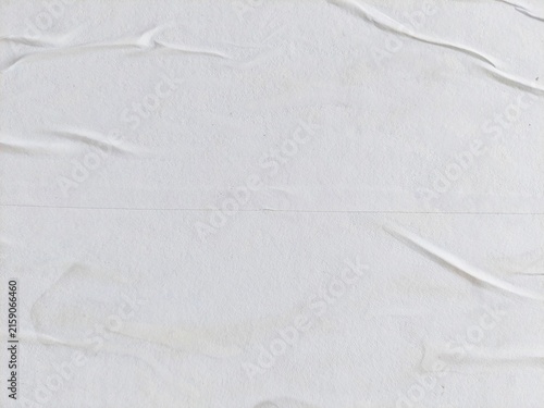 Abstract white crumpled paper poster background with wrinkled surface texture. Blank white creased paper poster with soft paper texture. Crushed and creased white poster paper surface.