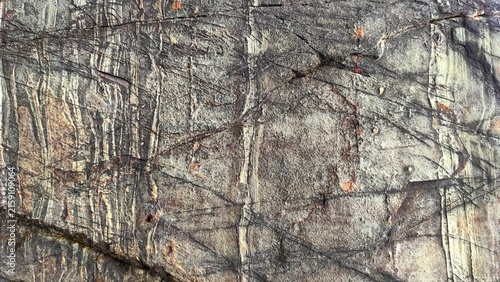 Foto Textured Gray Rock Surface with Rust Stains and Natural Layering