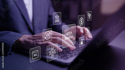 Digital open banking platform concept. Person using laptop with open banking, API and financial network icons, secure data sharing, online payment and fintech integration.