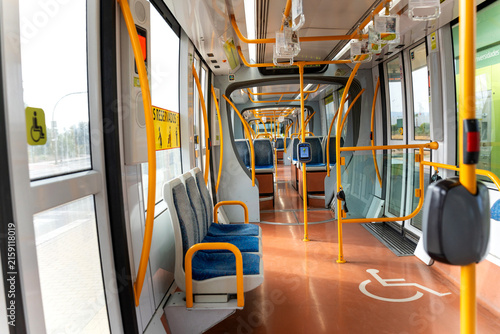 Empty interior of a modern public transport tram with accessible seating