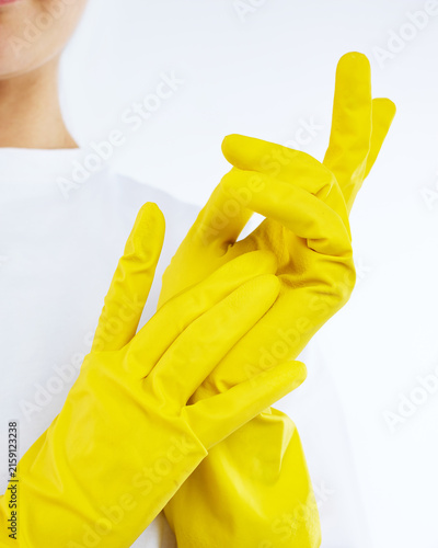 yellow rubber gloves on the hands of a woman