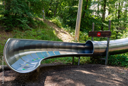 Binz, Ruegen, Mecklenburg-Western Pomerania, Germany-July 23, 2026: Stainless steel slide at the treetop walk