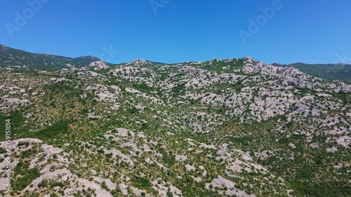 Rocky mountain landscape covered with low green shrubs