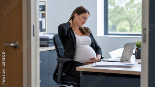 Pregnant professional easing neck strain while working at desk