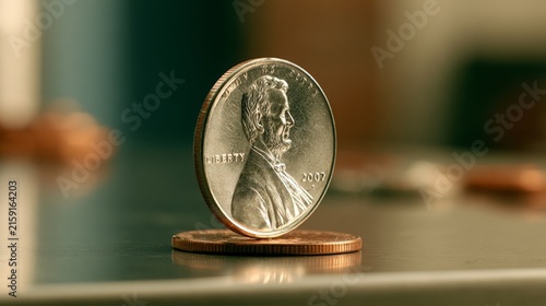 Close-up of a penny and a nickel displaying their details on a wooden surface.