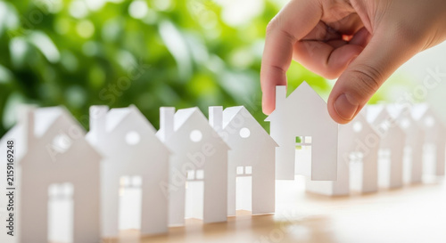 Hand Picking White Paper House in Row. Choose Right Home. Real Estate Concept. Housing Market. Property Investment Opportunity. Future Planning.