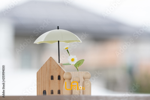 Obraz na płótnie Home insurance concept with family and house protected by glowing umbrella, symbolizing property protection, financial security, safety, coverage, insurance