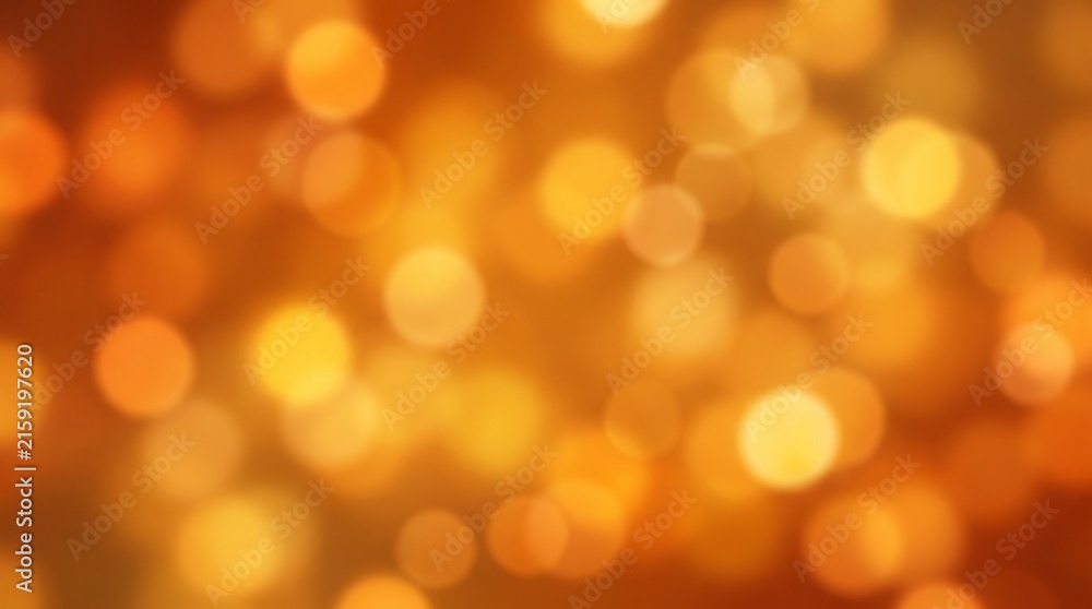 Fototapeta premium Golden blurred lights creating magical glowing bokeh effect for festive holiday backgrounds and warm artistic textures