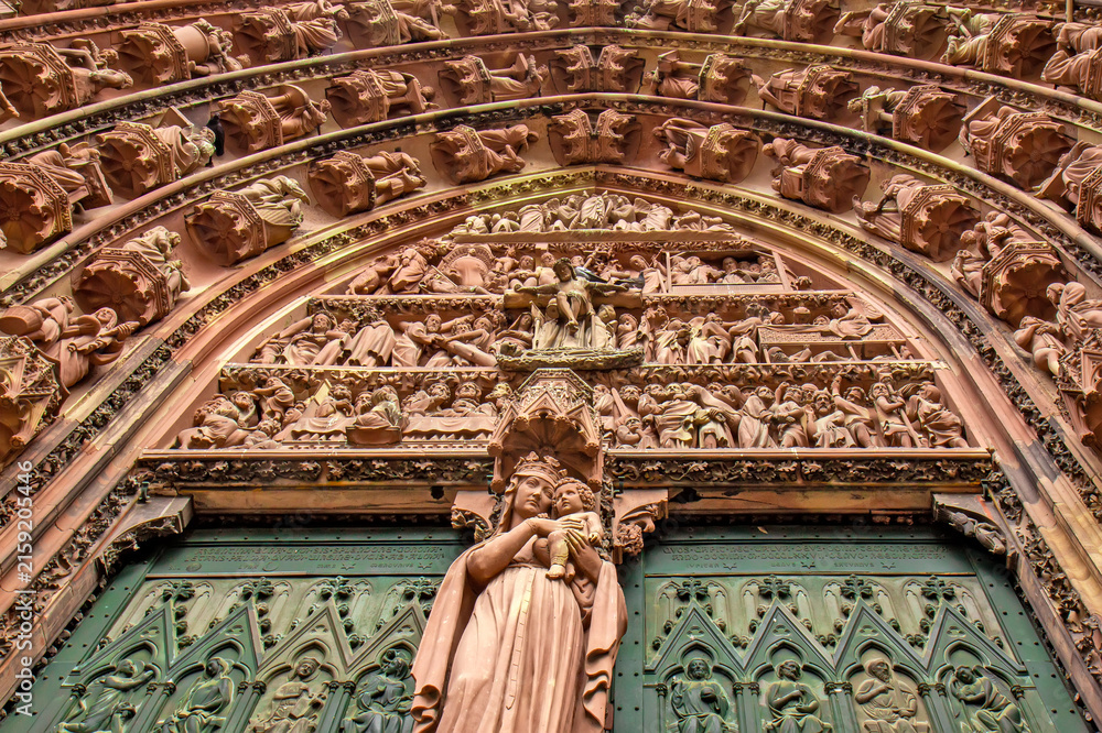 Fototapeta premium Detailed view of the richly sculpted Last Judgment portal on the western facade of Strasbourg Cathedral in Strasbourg, France.