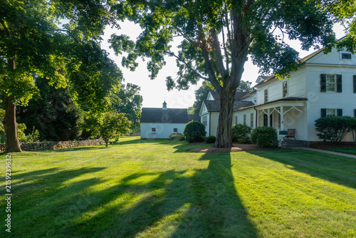 Late day shadows fall on the yard of a country home in Glastonbury, Connecticut (CT)