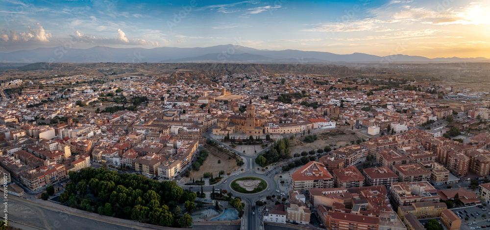 Fototapeta premium Aerial panorama of Guadix, Granada, Spain, with Cathedral and Sierra Nevada at sunset