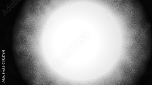 Monochrome vignette background with central white bright light and grainy noise texture framing