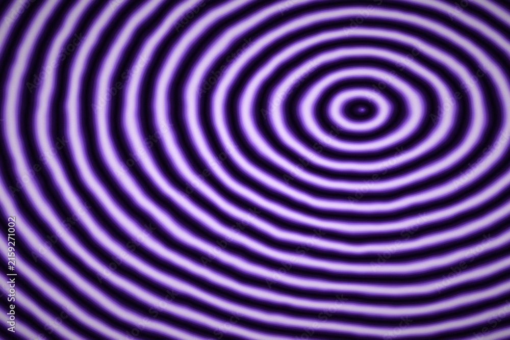 Naklejka premium Purple concentric circle pattern with subtle distortion creating abstract ripple effect on dark background