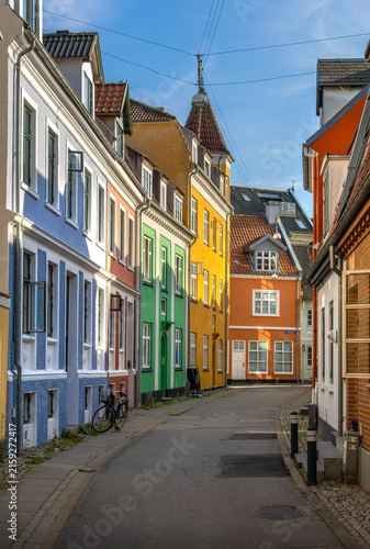 Colorful old town street of Aalborg, Denmark, with houses and bicycle