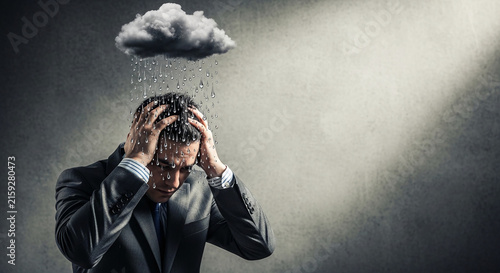 Man in suit with hands on head under a rain cloud, symbolizing stress, worry, and difficult times, perfect for business or lifestyle themes.
