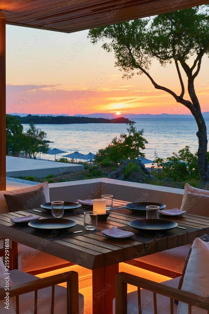 Fototapeta premium Sunset seaside outdoor dining table setting with ocean view for romantic evening background and terrace wallpaper