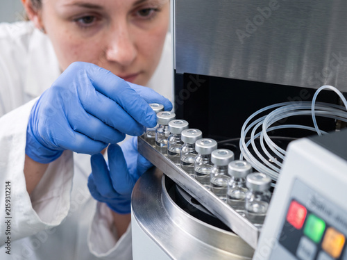 Analyst preparing sample vials for chromatography quality testing