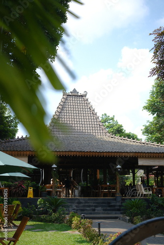 Traditional Javanese Joglo house architecture in a tropical garden resort setting