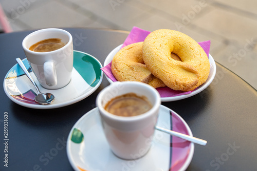Two espresso cups and a plate of traditional Bussolai cookies from Burano, Venice, Italy